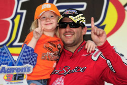 Tony Stewart celebrates with Britney Brewster in victory lane after winning the NASCAR Nationwide Series Aarons 312 at Talladega Superspeedway (Photo Credit: Rusty Jarrett/Getty Images for NASCAR)