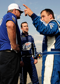 (Left to right) Crew chief Pat Tryson and Penske Racing teammates Kurt Busch and Ryan Newman debrief after NASCAR Sprint Cup Series practice at Darlington Raceway for the Dodge Challenger 500 (Photo Credit: Rusty Jarrett/Getty Images for NASCAR)