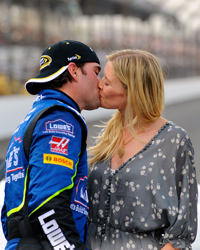 Jimmie Johnson, driver of the #48 Lowe\'s Chevorlet, celebrates with wife Chandra after winning the NASCAR Sprint Cup Series Allstate 400 at the Brickyard at Indianapolis Motor Speedway on July 27, 2008 in Indianapolis, Indiana. (Photo by Sam Greenwood/Getty Images for NASCAR)