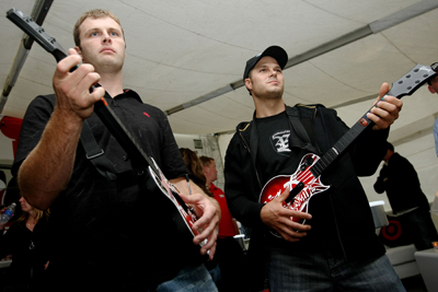 Travis Kvapil and David Gilliland play at a Guitar Hero: Aerosmith demonstration at the Target Chip Ganassi Racing hospitality tent at New Hampshire Motor Speedway on Saturday night (Photo Credit: Chris McGrath / Getty Images for NASCAR)