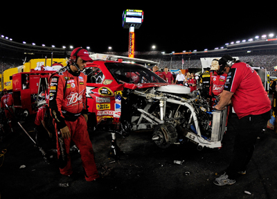 Kasey Kahne's crew works on his No. 9 Budweiser Dodge after a seven car accident on Lap 216. Kahne finished 40th and dropped from 11th to 14th in the standings. (Photo Credit: Rusty Jarrett/Getty Images for NASCAR)
