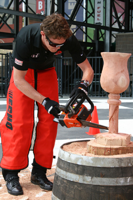IndyCar driver Scott Dixon carves wood with a chainsaw at Infineon Raceway (photo credit: Gary Phillips)