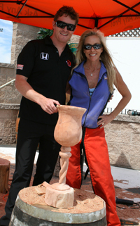 IndyCar driver Scott Dixon poses with Chainsaw Chick Cherie Currie at Infineon Raceway