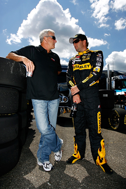 Former driver and now TV commentator Dale Jarrett chats with driver of the No. 19 Stanley Dodge Elliott Sadler during a Sprint Cup Series practice at Michigan International Speedway earlier this year. (Photo Credit: Jason Smith/Getty Images for NASCAR)