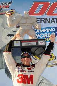 Hoisting the Monster Mile trophy above his head, Greg Biffle celebrates his NASCAR Sprint Cup Series Camping World RV 400 win Sunday at Dover International Speeday. (Photo Credit: Grant Halverson/Getty Images for NASCAR)