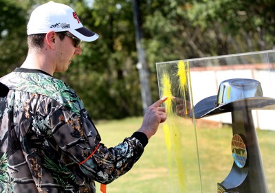 NASCAR Sprint Cup Series star Kyle Busch signs his name with the paint splatter on the prize -- the Dickies 500 trophy -- after he and his team defeated the local Dallas/Fort Worth media in paintball warfare for a Texas Motor Speedway media event Tuesday, Sept. 30, at Fun On The Run Paintball Park in Fort Worth, Texas. (Photo By Tom Pennington/Getty Images for the Texas Motor Speedway)