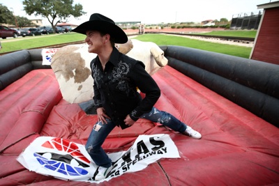 NASCAR Sprint Cup Series driver Scott Speed limbers up before he tangles with the mechanical bull again in the Fort Worth Stockyards Tuesday, October 21, 2008.    (Photo By Tom Pennington/Getty Images for the Texas Motor Speedway)