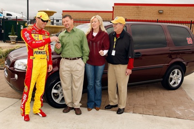 Kevin Harvick, driver of the No. 29 Shell-Pennzoil Chevrolet, presents a minivan to Robert Ard, the son of former Nationwide Series Champion Sam Ard, while DeLana Harvick and Jim Hunter, Vice President of Corporate Communications for NASCAR join them outside the Media Center, prior to practice for the NASCAR Sprint Cup Series Pep Boys Auto 500 at Atlanta Motor Speedway on Saturday. (Photo Credit: Chris Graythen/Getty Images)