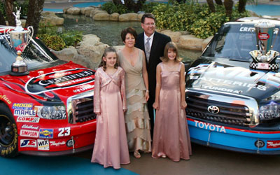 NASCAR Craftsman Truck Series champion Johnny Benson stands with (left to right) daughter Mikayla, wife Debbie and daughter Katelyn in the Seminole Paradise Courtyard at Seminole Hard Rock Hotel & Casino in Hollywood, Fla. (Photo Credit: Marc Serota/Getty Images for NASCAR)