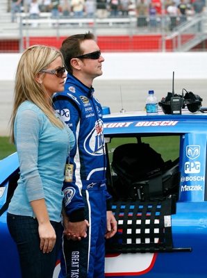 Kurt Busch, driver of the No. 2 Miller Lite Dodge, and his wife Eva participate in pre-race activities on pit road before the start of Sunday's NASCAR Sprint Cup Series Kobalt Tools 500 at the Atlanta Motor Speedway. (Photo Credit: Kevin C. Cox/Getty Images)