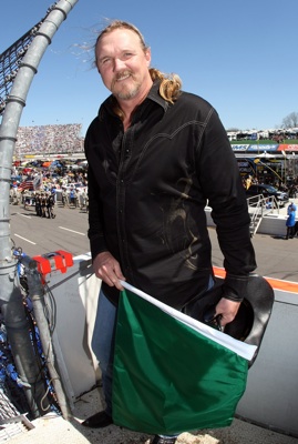Country music star Trace Adkins smiles in the flagstand before waving the green flag to start the Goody's Fast Pain Relief 500 at Martinsville Speedway. (Photo Credit: Nick Laham/Getty Images)