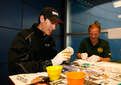 Joey Logano and Kenny Wallace dye Easter eggs as part of a driver and media contest on Friday. (Photo Credit: John Sommers II/Getty Images for NASCAR)