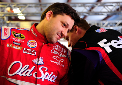 Tony Stewart, driver of the No. 14 Old Spice/Office Depot Chevrolet chats with former teammate Denny Hamlin, driver of the No. 11 FedEx Toyota in the garage during Friday's practice for the NASCAR Sprint Cup Series Aaron's 499 at Talladega Superspeedway. Earlier in the day, Stewart held a news conference about the 2009 Prelude to the Dream. (Photo Credit: Rusty Jarrett/Getty Images for NASCAR)