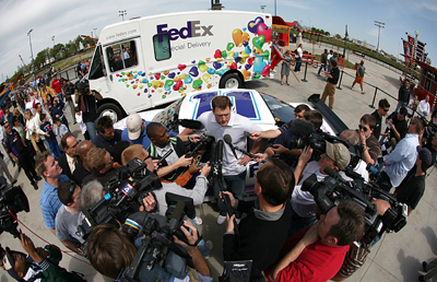 Dallas Cowboys tight end Jason Witten (center) talks with the media after racing NASCAR driver Denny Hamlin around the track at SpeedZone in Dallas, Texas Wednesday, April 1, 2009. The pair were racing to raise awareness for the March of Dimes and the 2009 March for Babies. (Photo By Tom Pennington/Getty Images for the Texas Motor Speedway)