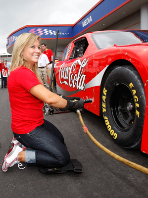 Olympic Gold Medalist and Dancing With the Stars winner Shawn Johnson learns how to change a tire before the Coca-Cola 600 at Lowe's Motor Speedway. (Photo Credit: Streeter Lecka/Getty Images for NASCAR)