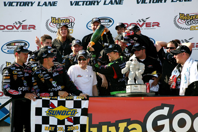 Brad Keselowski douses JR Motorsports owner Dale Earnhardt Jr. with champagne Saturday in Dover International Speedway's Victory Lane after winning the NASCAR Nationwide Series Heluva Good! 200. (Photo Credit: Jerry Markland/Getty Images for NASCAR)