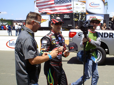 Jeff Gordon signs an autograph for a fan before the start of the Toyota/SaveMart 350 at Infineon Raceway on Sunday, June 21, 2009 (photo credit: The Fast and the Fabulous)