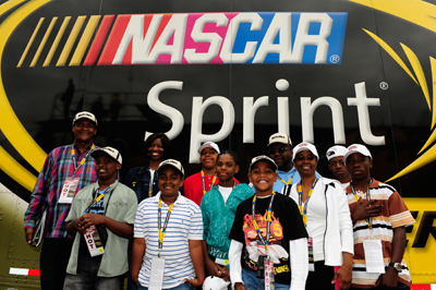 The group, Driven to Succeed, led by Tyrone McIntyre and Renee V. Wallace of Detroit Mich., attended the NASCAR Camping World Truck race on Saturday. As part of an ongoing effort to reach out to and engage the community, African American youth ages 7-17 from the local Detroit community spent a day at Michigan International Speedway learning about NASCAR and getting a behind-the-scenes look at what it takes to host a major race weekend. (Photo Credit: Rusty Jarrett/Getty Images for NASCAR)
