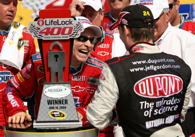 Mark Martin, driver of the No. 5 CARQUEST/Kellogg's Chevrolet, is congratulated in victory lane by teammate Jeff Gordon, driver of the No. 24 DuPont/National Guard 'Year of the NCO' Chevrolet, after Martin wins the NASCAR Sprint Cup Series LifeLock 400 at Michigan International Speedway on Sunday in Brooklyn, Mich. Gordon finished second. (Photo Credit: Ezra Shaw/Getty Images)
