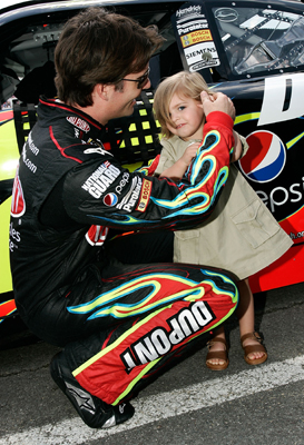 Jeff Gordon, driver of the No. 24 DuPont Chevrolet, gives daughter Ella Sophia earplugs on pit road just before the start of the NASCAR Sprint Cup Series Pocono 500 on Sunday at Pocono Raceway in Long Pond, Penn. (Photo Credit: Jason Smith/Getty Images)