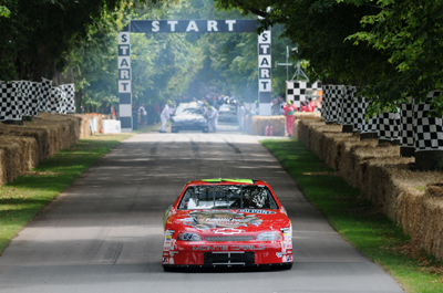 Driving the No. 24 Hendrick Motorsports T-Rex car, Landon Cassill takes on the hill climb Saturday at the Goodwood Festival of Speed in Chichester, England. (Photo Credit: Ed Heuvink)