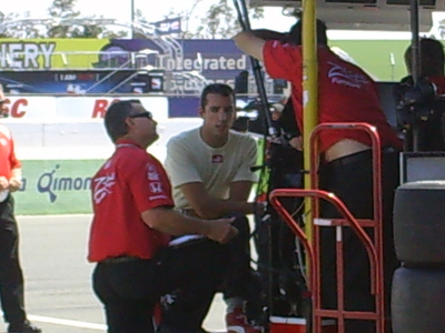 Justin Wilson chats with his team after practice on Saturday, August 22, 2009 at the Indy Grand Prix of Sonoma at Infineon Raceway (photo credit: The Fast and the Fabulous)