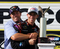 (Left to right) Joe Gibbs Racing President J.D. Gibbs congratulates Denny Hamlin, driver of the No. 11 FedEx Express Toyota, on Monday after Hamlin's fifth career NASCAR Sprint Cup Series win in the Sunoco Red Cross Pennsylvania 500 and third at Pocono Raceway in Long Pond, Pa. (Photo Credit: Chris Trotman/Getty Images for NASCAR)