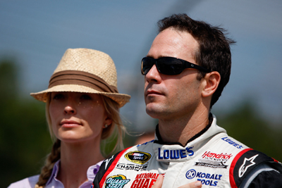 Jimmie Johnson, driver of the No. 48 Lowe's Chevrolet, stands with his wife Chandra on the grid prior to the NASCAR Sprint Cup Series Heluva Good! Sour Cream Dips at Watkins Glen International on Monday in Watkins Glen, N.Y. (Photo Credit: Chris Graythen/Getty Images)