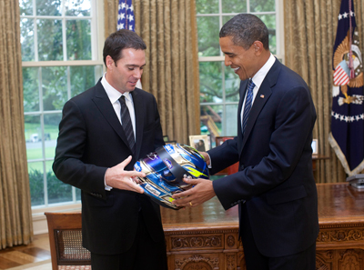 (Left to right) Three-time defending NASCAR Sprint Cup Series champion Jimmie Johnson presents President Barack Obama with a helmet in the Oval Office at the White House in Washington, D.C. on Wednesday. (Photo Credit: Official White House Photo)