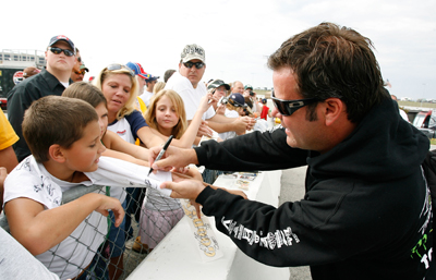 Robby Gordon, driver of the No. 7 Polaris Off Road Vehicles Toyota, signs autographs before Saturday's practice for the NASCAR Sprint Cup Series Pep Boys Auto 500 at Atlanta Motor Speedway on Sunday in Hampton, Ga. (Photo Credit: Geoff Burke/Getty Images for NASCAR)