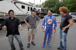 Tony Stewart, driver/owner at Stewart-Haas Racing, pictured in center in his BURGER KING fire suit, shares some laughs with actor, Erik Estrada (left) and comedian/actor, Carrot Top (right), during a break behind the scenes of Burger King Corp.s ad shoot, The Tony Stewart School of Endorsements.