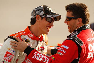 Joey Logano, driver of the No. 20 Home Depot Toyota, shares a laugh on pit road with Tony Stewart, driver of the No. 14 Office Depot Chevrolet, during qualifying on Friday for Saturday's NASCAR Sprint Cup Series Chevy Rock & Roll 400 at Richmond International Raceway. (Photo Credit: Chris Graythen/Getty Images)