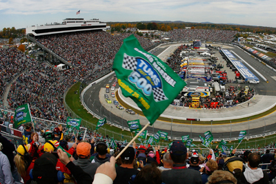 Fans wave green flags to start the TUMS Fast Relief 500 at Martinsville Speedway. The fans served as the Grand Marshals and Honorary Starters for the race. (Photo Credit: Jason Smith/Getty Images for NASCAR)