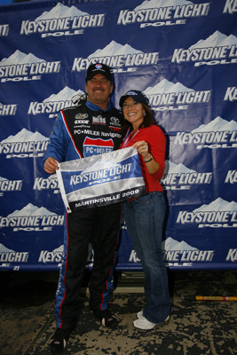 Mike Skinner poses with wife Angie after winning the pole for the Kroger 200 at Martinsville Speedway, his NASCAR Camping World Truck Series leading 50th career pole. (Photo Credit: Jason Smith/Getty Images for NASCAR)