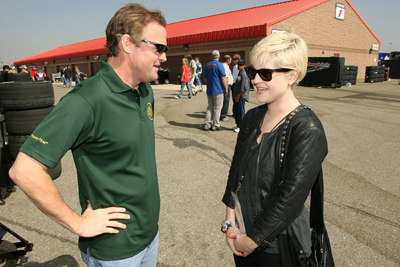 (Right to left) Dancing With The Stars competitor Kelly Osbourne meets NASCAR Nationwide Series driver Kenny Wallace before the Copart 300 Saturday at Auto Club Speedway in Fontana, Calif. Osbourne was the honorary starter for Saturday's NASCAR Nationwide Series Copart 300. (Photo Credit: Stephen Dunn/Getty Images for NASCAR)