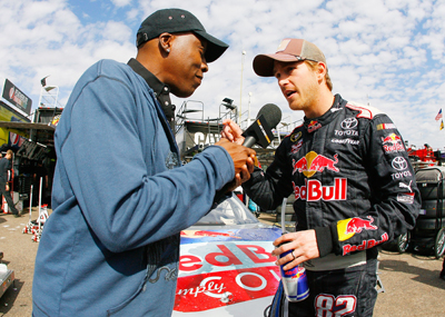 Arsenio Hall interviews Scott Speed at Phoenix International Raceway for a segment for the Jay Leno Show. (Photo Credit: Jason Smith/Getty Images for NASCAR)