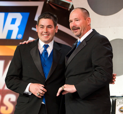 George Brunnhoelzl III (left) presents his father, George Jr. with a matching championship ring. (Photo Credit: Chris Keane/Getty Images for NASCAR)