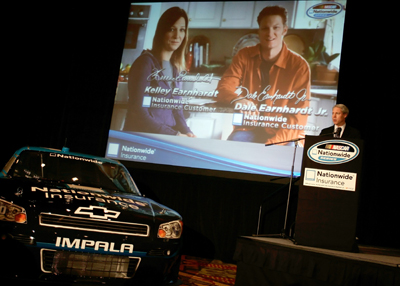 Nationwide Brand and Advertising Officer John Aman introduces a new television ad with Kelley Earnhardt and Dale Earnhardt Jr. during the Nationwide stop Wednesday on the NASCAR Sprint Cup Media Tour Hosted by Charlotte Motor Speedway in Concord, N.C. (Credit: Jason Smith/Getty Images)