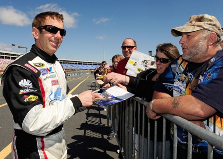 Greg Biffle chats with and sign autographs for fans who came out Tuesday for the NASCAR Sprint Cup Series test at Charlotte Motor Speedway.(Credit: Rusty Jarrett/Getty Images for NASCAR)