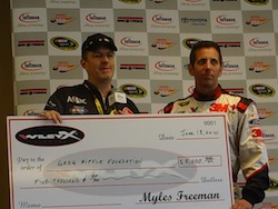 Greg Biffle accepts a $5,000 check for his foundation from WileyX