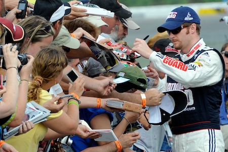 Before qualifying third for Sunday’s Gillette Fusion ProGlide 500, Dale Earnhardt Jr. took time to sign autographs for fans at Pocono Raceway. (Credit: John Harrelson/Getty Images for NASCAR)