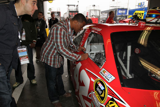 The Baltimore Raven's Ray Rice visits the NASCAR Sprint Cup Series garage and takes a look in the No. 42 Target Chevrolet Wednesday at Daytona International Speedway in Daytona Beach, Fla. (Credit: Motorsports Images and Archives)