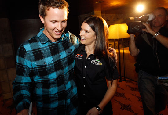 Daytona 500 champion Trevor Bayne is congratulated by NASCAR driver Danica Patrick on Thursday in Phoenix, Ariz. Bayne and Patrick made a special appearance at Phoenix International Raceway's annual "Night of Champions" charity event. (Credit: Tom Pennington/Getty Images for Phoenix International Raceway)