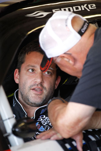 Tony Stewart, driver of the No. 14 Mobil 1/Office Depot Chevrolet, talks his father, Nelson, during practice for the NASCAR Sprint Cup Series Samsung Mobile 500 at Texas Motor Speedway on Apr. 7 in Fort Worth, Texas. (Credit: Matthew Stockman/Getty Images)