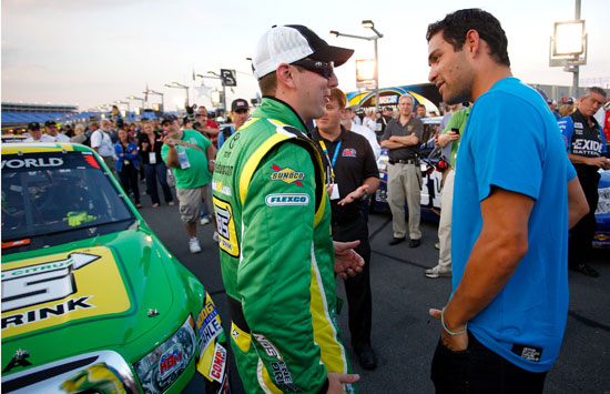New York Jets quarterback Mark Sanchez talks with Kyle Busch on the grid before the start of the North Carolina Education Lottery 200 at Charlotte Motor Speedway (Credit: Jeff Zelevansky/Getty Images for NASCAR)