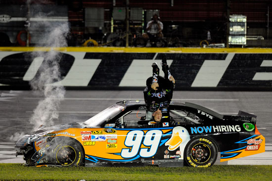 Carl Edwards does his trademark victory backflip after tearing up his car sliding through the infield grass at Charlotte Motor Speedway. (Credit: Jared C. Tilton/Getty Images for NASCAR)