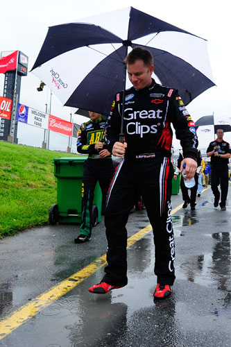 NASCAR Nationwide Series driver Jason Leffler splashes a puddle as he waits through over an hour rain delay before the start of the 5-hour Energy 200 on Saturday at Dover International Speedway in Dover, Del. (Credit: Jason Smith/Getty Images for NASCAR)