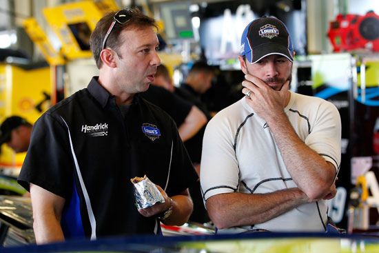 NASCAR Sprint cup Series No. 48 Lowe's Chevrolet crew chief Chad Knaus (left) talks with driver Jimmie Johnson (right) in the garage during the testing session at the NASCAR Sprint Cup Series at Kentucky Speedway on July 7 in Sparta, Ky. The No. 48 Hendrick Motorsports team was the fastest in this session. (Credit: Geoff Burke/Getty Images for NASCAR)