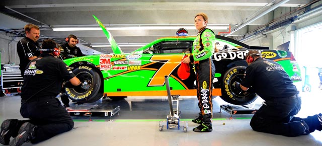Danica Patrick stands beside the No. 7 GoDaddy.com Chevrolet as crew members work in the garage area, during practice for the NASCAR Nationwide Series NAPA Auto Parts 200 at Circuit Gilles Villeneuve on Aug. 19 in Montreal, Canada. (Credit: Jason Smith/Getty Images)
