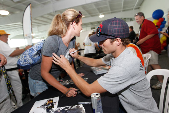 Kasey Kahne, driver of the No. 4 Red Bull Toyota, signs an autograph for a race fan at the largest 2011 NASCAR Sprint Cup Series autograph session held at Indianapolis Motor Speedway on July 30 in Indianapolis, Ind. (Credit: Getty Images for NASCAR)